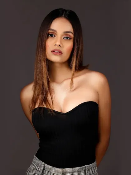 A classic three-quarter portrait against a solid grey background. This is a staple for any actor or model's portfolio, focusing on a natural and engaging expression.