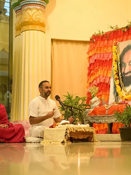 An instructor leads a Guru Puja session in front of my portrait. The ceremony is an offering of gratitude to the entire tradition of masters who have carried the flame of wisdom through the ages.