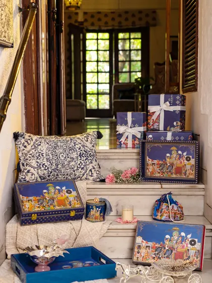 A display of gift boxes from the Golden Dunes collection, showcasing the intricate artwork and luxurious packaging. Each box is a piece of art, designed to be cherished long after the wedding is over.