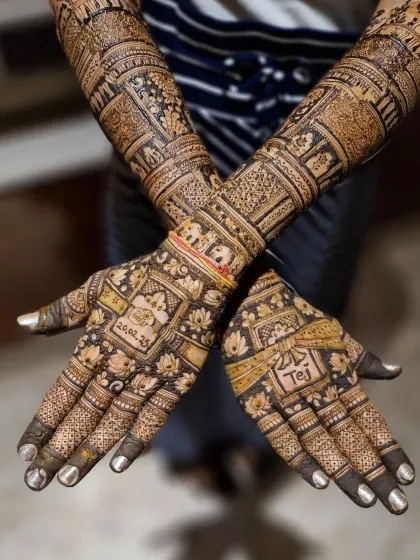 A different angle of the personalized traditional mehendi, showing how the date and name are seamlessly integrated with classic floral and elephant motifs.