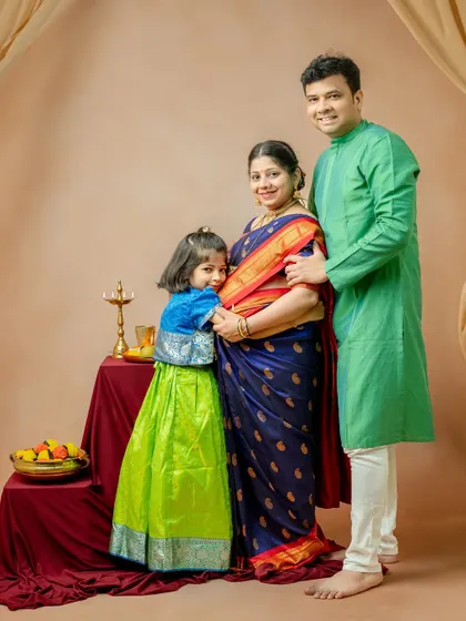 Another angle of the family portrait, this time with the daughter lovingly hugging her mother's baby bump. It’s a sweet, candid moment that shows the excitement of the whole family.