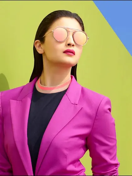 Fashion is a playground of color and form. In this campaign shoot with Alia Bhatt, we used bold, contrasting colors to create a vibrant and modern look. The slicked-back hair and sharp styling give the portrait a high-fashion, graphic quality that really stands out.