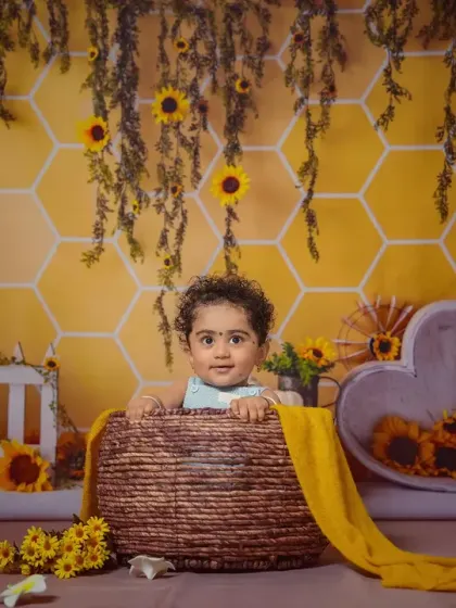 A full view of our cute honey bee setup, complete with a honeycomb background and honey pots.