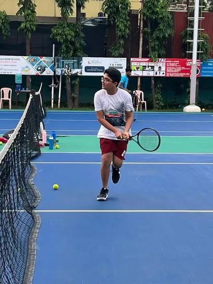 A junior player works on his approach shot during a drill. We teach our students not just how to hit the ball, but how to construct points and move with purpose on the court.