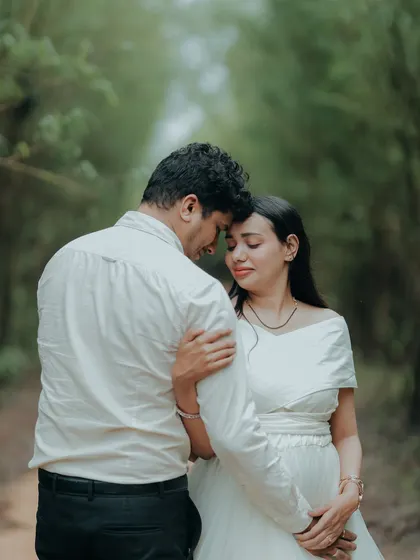 An intimate and emotional portrait of an expecting couple. The simple elegance of the white gown keeps the focus on their connection.