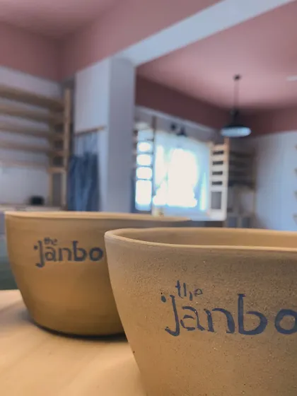 A row of our large, hand-painted "The Janbo" bowls, waiting in the studio.