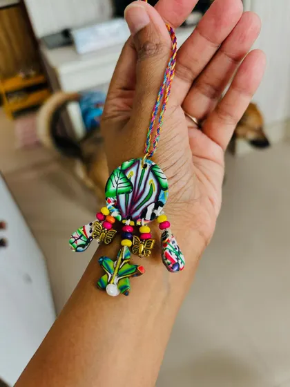 Wearing the exquisite Lumba to show its size and how the colors pop. The thread is also hand-braided with multiple colors to match the vibrant design.