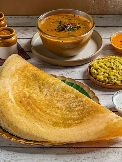 A classic masala dosa folded into a half-moon, served with potato filling, sambar, and chutney.