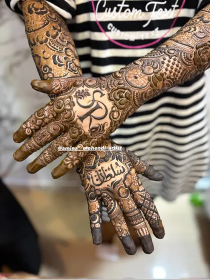 A closer view of the 'SR' and 'Sultan' mehendi, highlighting the detailed work on the palms.