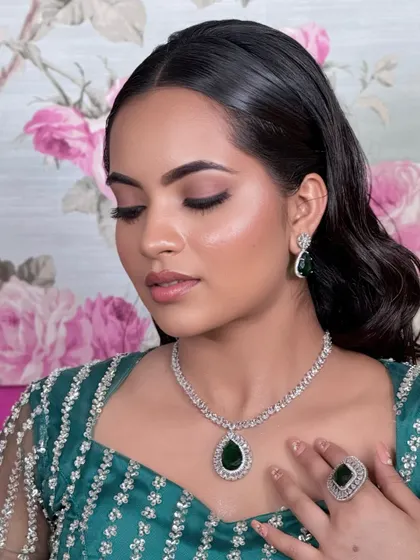 This elegant CZ necklace with a large emerald drop is a statement piece. It's perfect for adding a touch of colour and sophistication to any modern outfit.