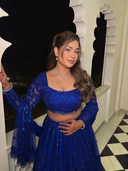 A final pose showing off the complete look. The soft waves and glowing makeup make for a picture-perfect Sangeet appearance.