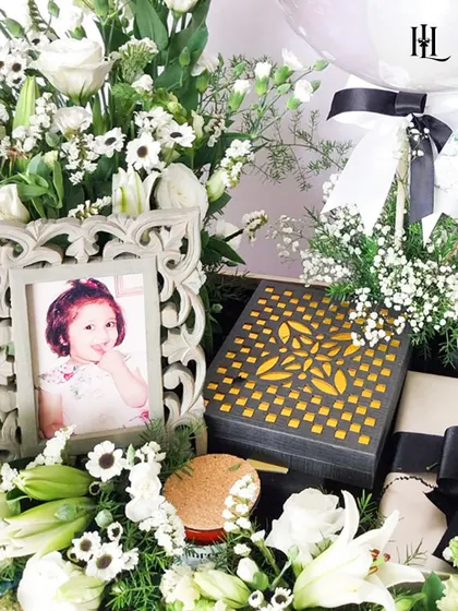 A close-up of the elegant 30th birthday hamper. The intricate design of the photo frame, the luxurious gift box, and the fresh white flowers showcase a classic and timeless style.