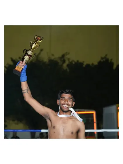 A champion holding his trophy high. This victory at the state level is a result of countless hours of dedicated training.