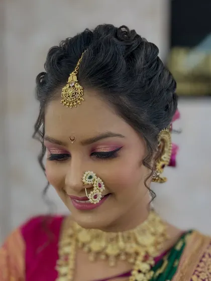 A close-up of the finished demonstration look. The soft pink eyeshadow, winged liner, and traditional 'nath' create a beautiful and classic bridal style.