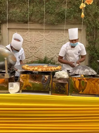 A live tawa station at a Haldi ceremony. My chefs are preparing hot and fresh appetizers for guests, adding an element of theatre to the dining experience.