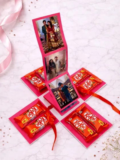 The big reveal! This photo explosion box opens up to display a waterfall of pictures in the center, with KitKat chocolates on each of the four flaps.