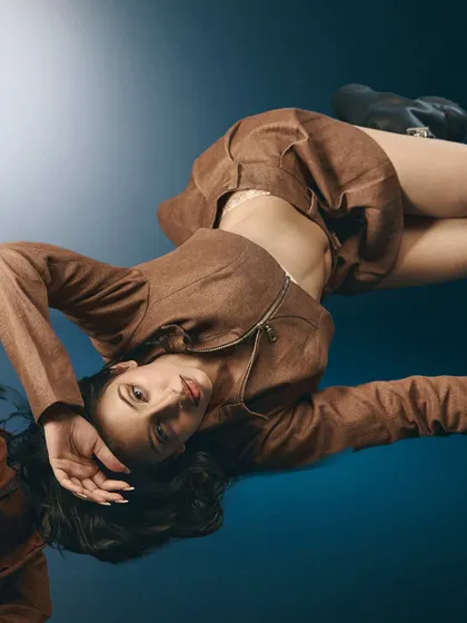 Using a mirror on the floor, this shot creates a disorienting, gravity-defying pose. The reflection and the Y2K styling give it a cool, futuristic feel.