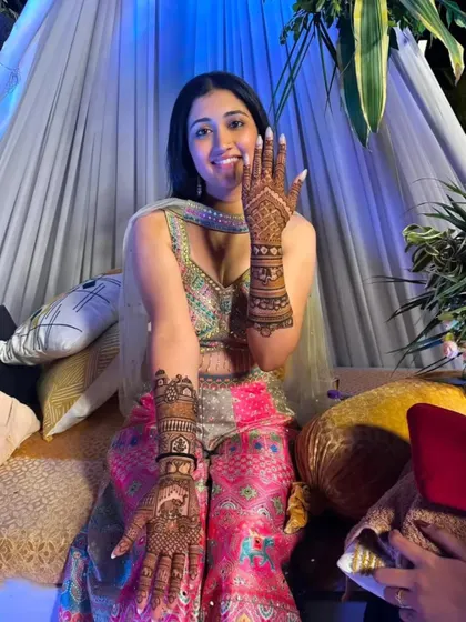 A full view of the bride's mehandi, showing the beautiful design on both her hands.