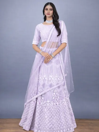 A full frontal view of the lavender lehenga, highlighting the geometric and floral resham work. The matching embroidered blouse and sheer dupatta create a harmonious and classy look.