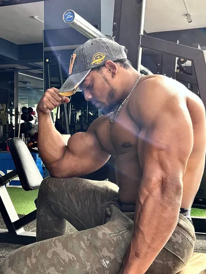 Finding strength in every stride. A side view of a bodybuilder's impressive bicep peak and arm definition, the result of disciplined training.