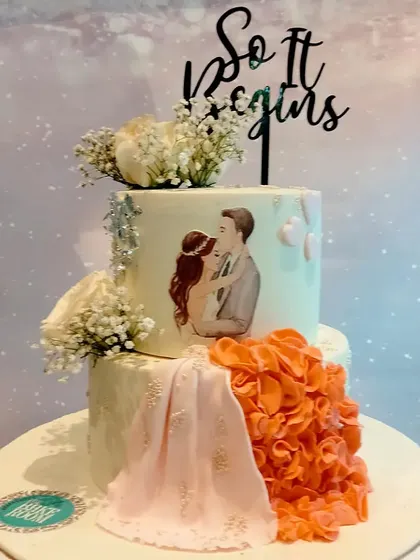 Another take on the couple's cake, this time with a peach and orange ruffled dress detail. I love customizing these designs to match the couple's outfits and theme.