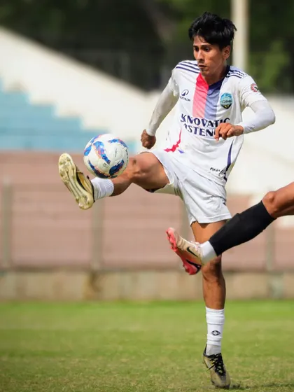 A dynamic action shot of our player executing a volley during the match.
