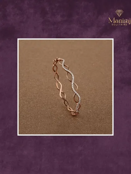 Subtle yet striking. This delicate rose gold bangle features a beautiful wave-like pattern, with one section paved in diamonds. It's the perfect piece to complement your everyday elegance.