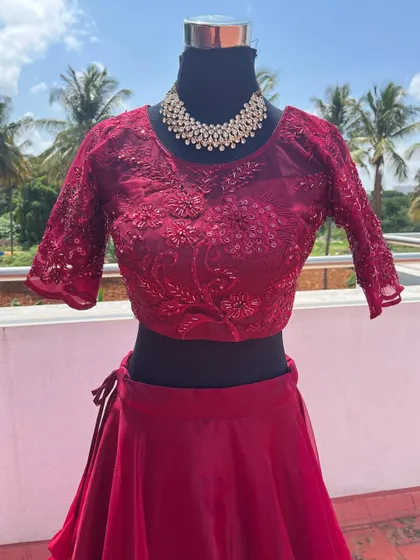 A close-up of the wine-red embroidered blouse.