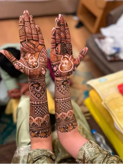 A unique take on portrait mehndi, with the faces of the bride and groom drawn in a more illustrative, artistic style.