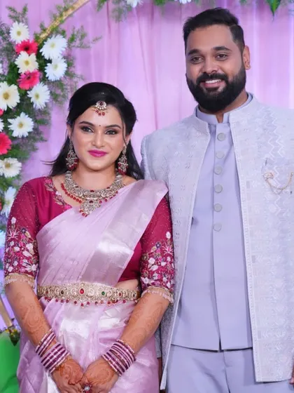 The happy couple posing for a photo, their outfits perfectly complementing each other.