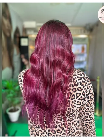 The back view of the wine-colored hair, with beautiful waves that highlight the bold, captivating shade.