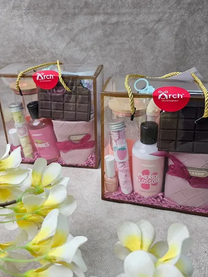 Two matching Rakhi hampers we created for a client's sisters. These transparent bags are filled with skincare, chocolates, and other pampering items, all beautifully arranged.