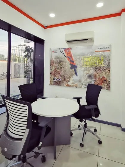 A small meeting space with a large window, providing natural light and a view outside. These bright, airy spaces are conducive to productive discussions.