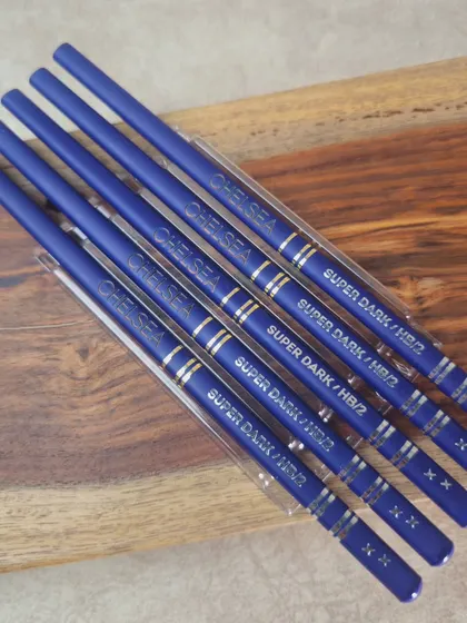 A close-up showing the name customization on each individual pencil within the DOMS set.