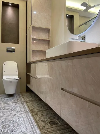 This bathroom design features a long, floating vanity with ample storage and open shelving. The patterned floor tiles are the star of the show, adding a decorative element to the space.