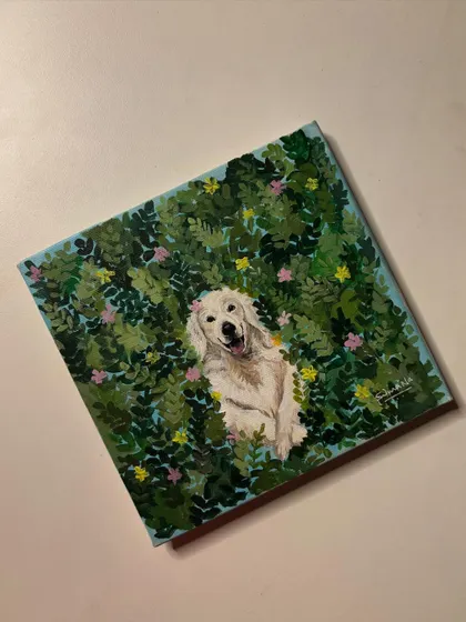 A different view of the Golden Retriever painting, showing the texture of the canvas and the lush, leafy background.