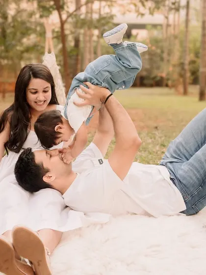 A playful father lifting his son upside down, a moment of pure, unscripted family fun.