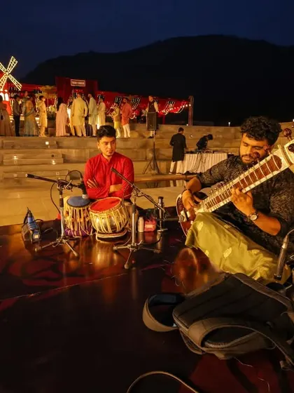The reception for Sonam and Ross was a grand affair with a stunning red windmill and live musicians. This wide shot shows the scale and creativity we bring to destination weddings.
