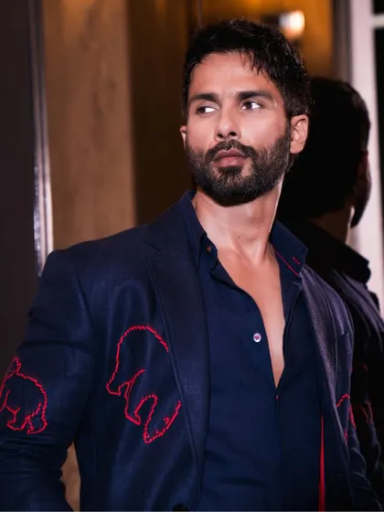 A great profile shot of Shahid, showing off the fit of the suit and the unique red embroidered details on the sleeves.