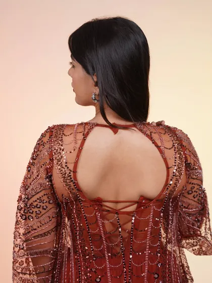 A back view of the rust-colored corset set, showing the beautiful lace-up detail. It's stunning from every angle.