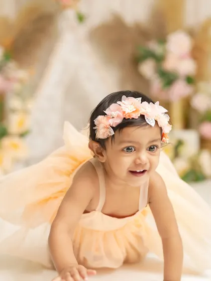 On the move! This crawling shot captures the energy and excitement of a baby exploring her surroundings during a beautiful boho-themed session.