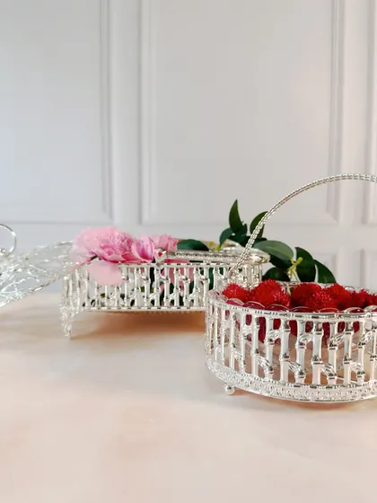 Another angle showcasing the different shapes and sizes of our silver-plated baskets. Whether for holding flowers or festive treats, they add a touch of elegance to any setting.