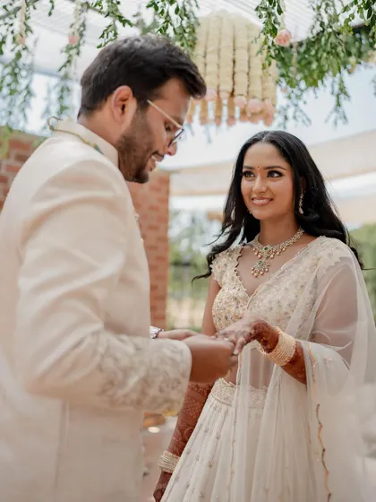 A stunning bride in a white lehenga, exuding grace and elegance. We use creative framing and lighting to capture a variety of beautiful portraits.