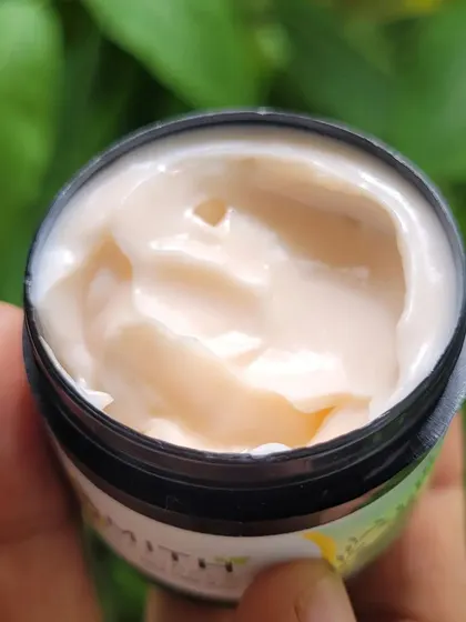 Look at the rich, creamy texture of my Vitamin C Cream. I hold it up to show you it's freshly made and packed with goodness. This cream is designed to help prevent sun damage, improve the appearance of dark spots, and give your skin a healthy glow.
