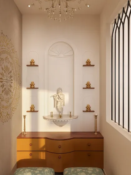 Inside the puja room, the mandir is designed with an arched niche that mirrors the entryway. Small shelves hold brass idols, and a beautiful mandala stencil on the wall adds a spiritual and artistic element.