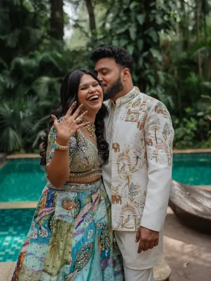 A fun, candid moment of the groom stealing a kiss. These spontaneous shots are often the most cherished, capturing the genuine joy and playfulness of the wedding day.