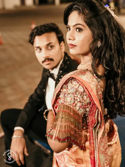 A stylish portrait of the couple at their reception, with the bride looking over her shoulder at the camera.