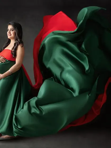 A dynamic and artistic shot using flowing fabric. The contrast between the red and green satin creates a visually stunning and powerful image.