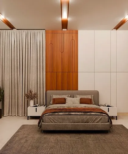 This bedroom blends warm wooden tones with modern design. The custom chevron wardrobe with gold accents adds a touch of luxury, while the neutral palette and soft lighting create a cozy, refined atmosphere.