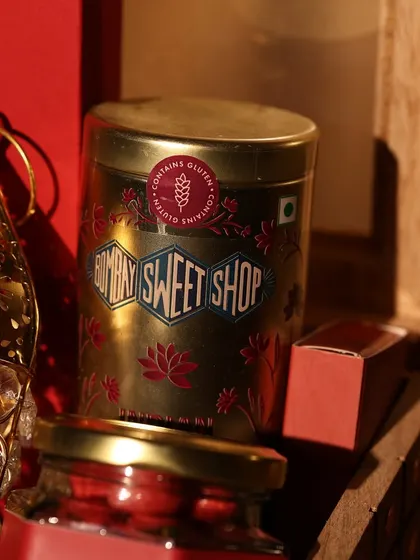 I often include premium treats in my hampers, like this tin from Bombay Sweet Shop, which adds a gourmet touch to the festive celebration.
